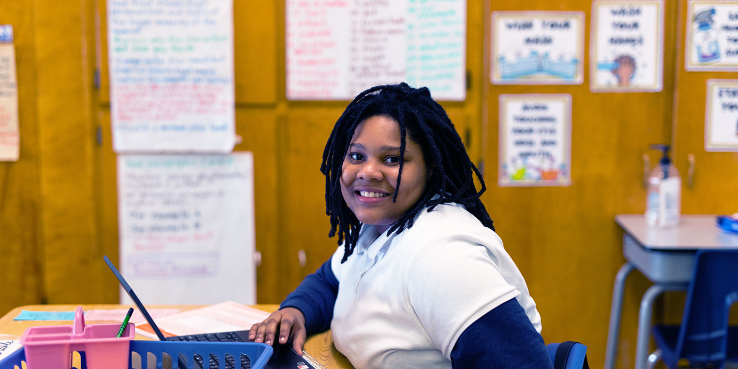 Smiling student at desk.
